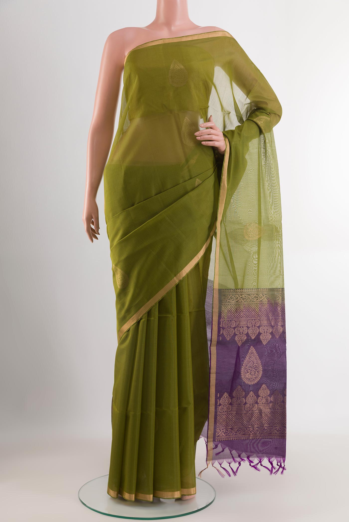 Green Blended Kora Cotton Saree with Zari Butta on the body and Zari Border.  displayed on a mannequin