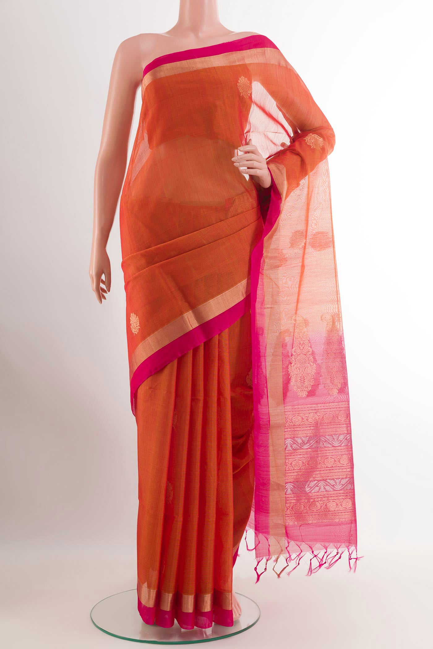 Orange Blended Kora Cotton Saree with Zari Butta on the body and Zari Border.  displayed on a mannequin