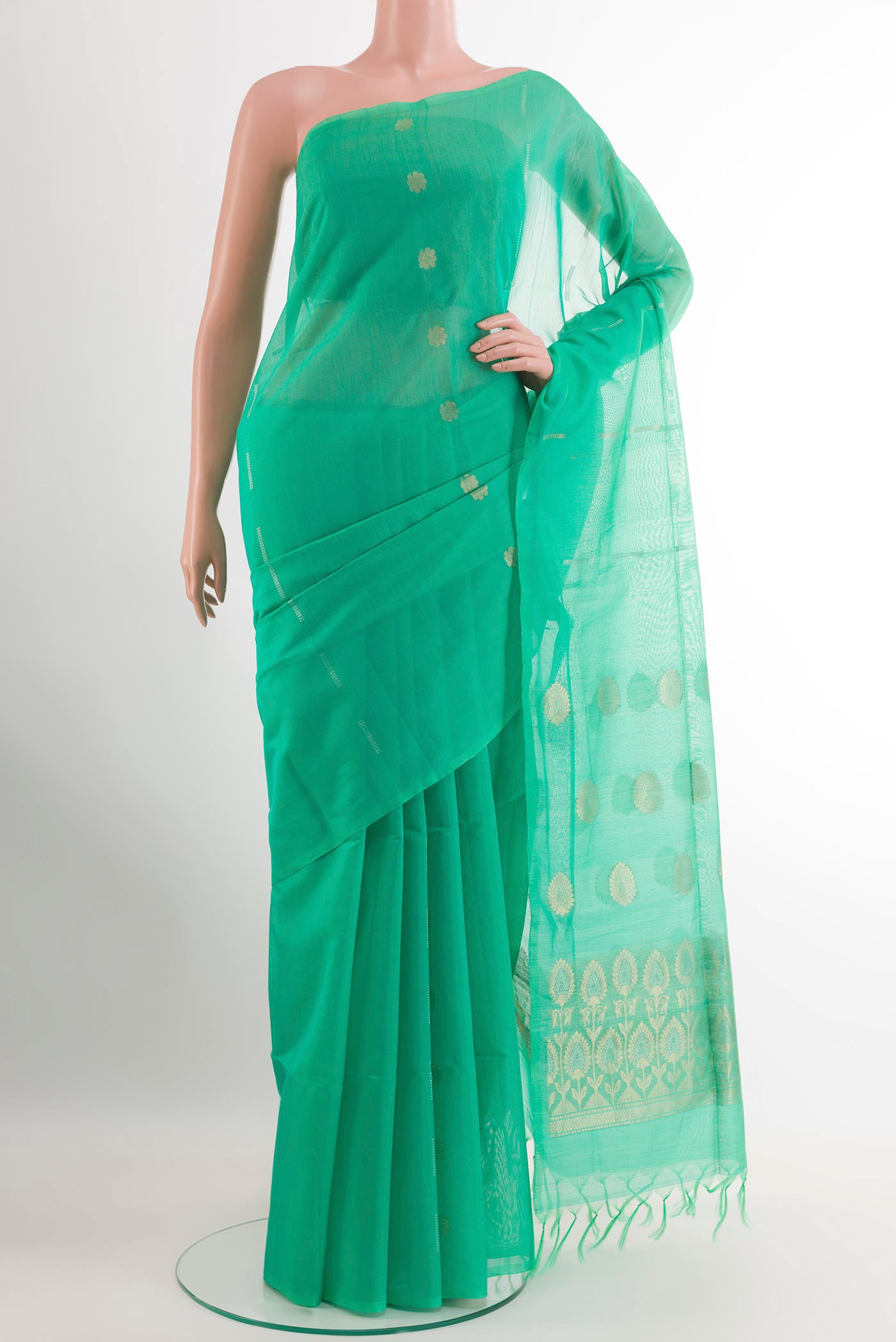 Green Blended Kora Cotton Saree with Zari Butta on the body and Zari Border.  displayed on a mannequin