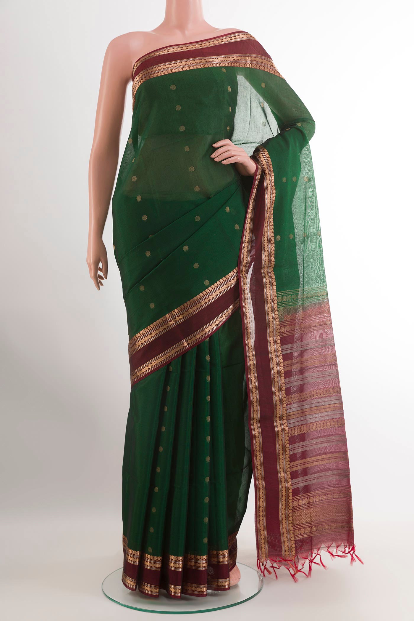 Green Kora Cotton Saree with Zari Butta on the body and Zari Border.  displayed on a mannequin