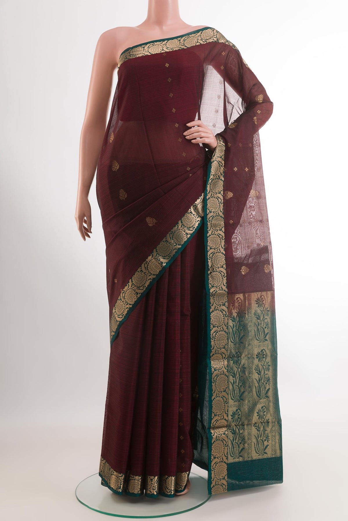 Maroon Blended Kora Cotton Saree with Zari Butta on the body and Plain Border.  displayed on a mannequin
