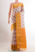 Off White Soft Silk Saree with Ikat design on the body and Zari Border.  displayed on a mannequin