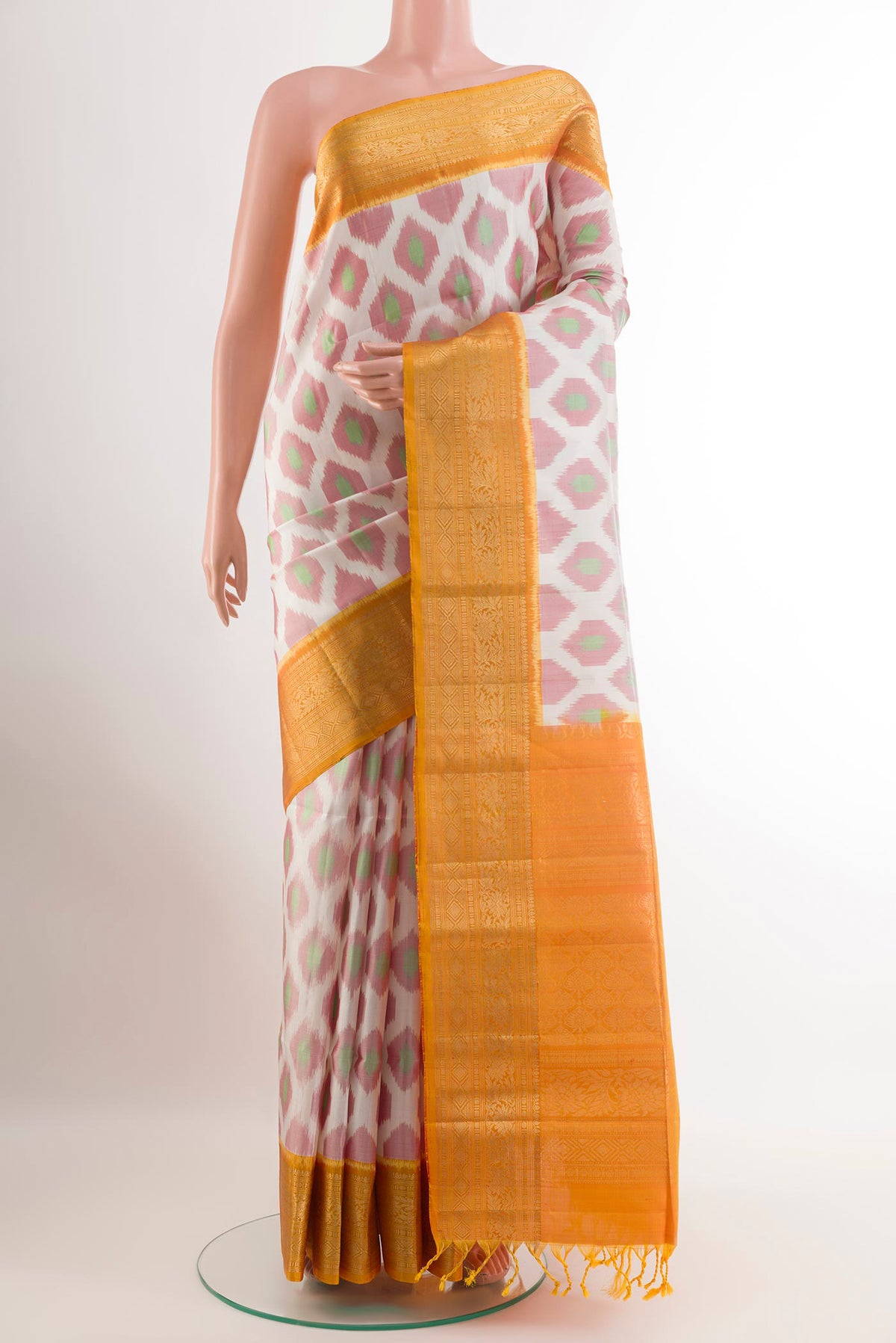 Off White Soft Silk Saree with Ikat design on the body and Zari Border.  displayed on a mannequin