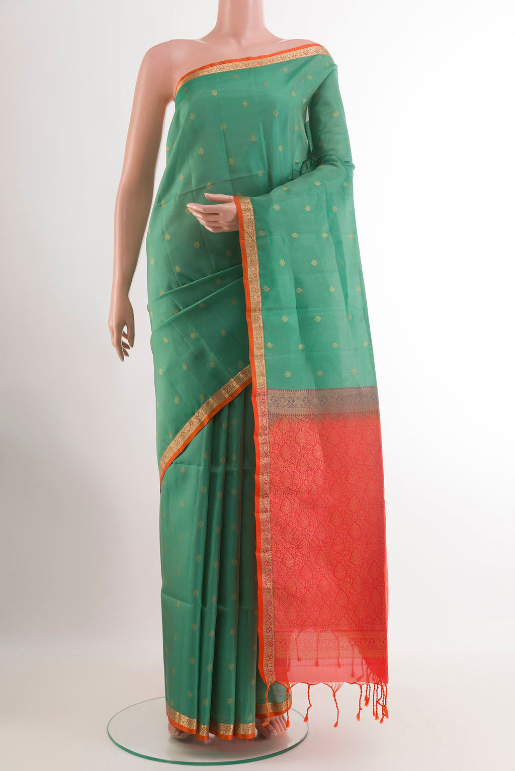 Sage Green Soft Silk Saree with Zari Butta on the body and Zari Border.  displayed on a mannequin