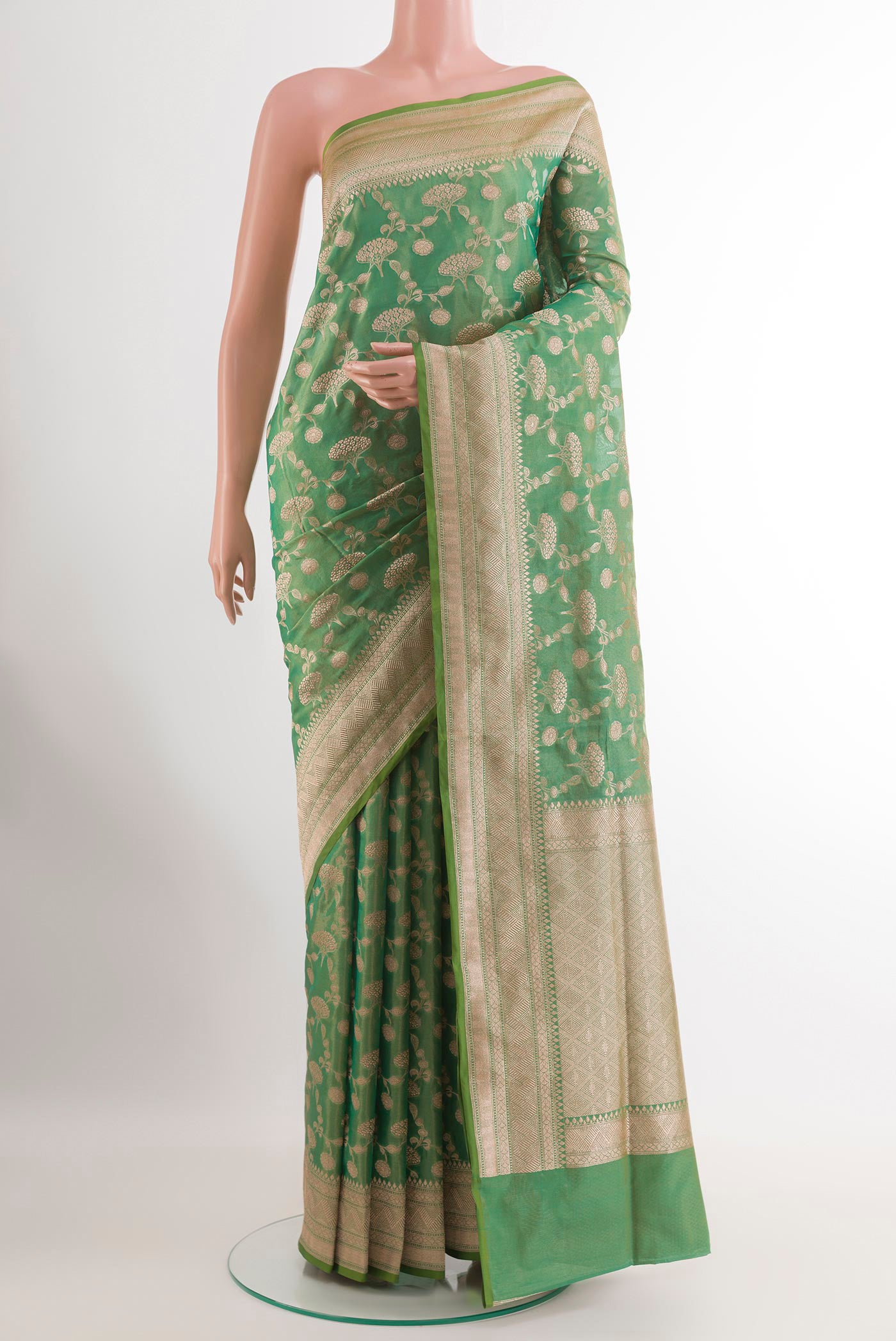 Green Banarasi Silk Saree with Zari Brocade on the body and Zari Border.  displayed on a mannequin