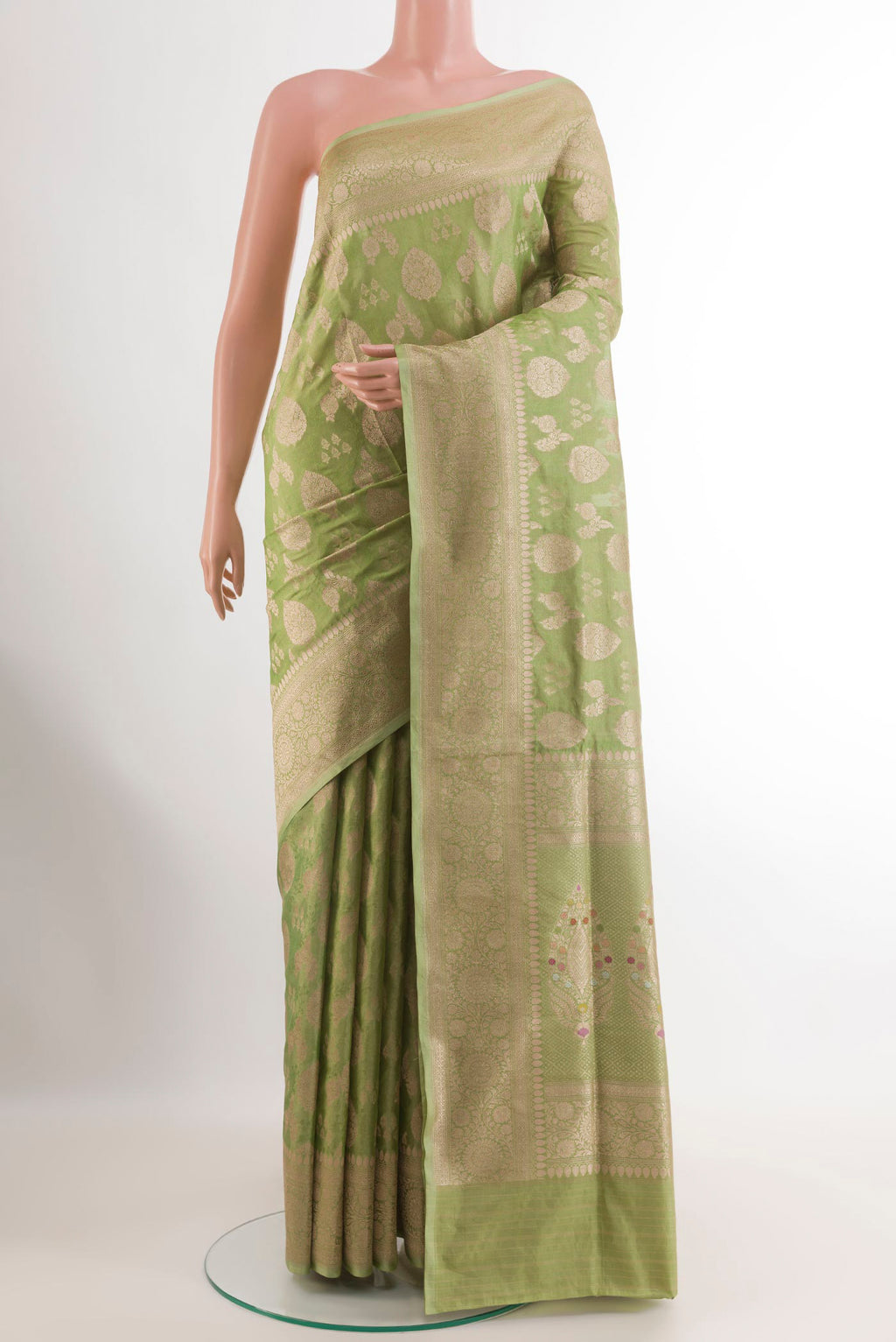 Green Banarasi Silk Saree with Zari Brocade on the body and Zari Border.  displayed on a mannequin