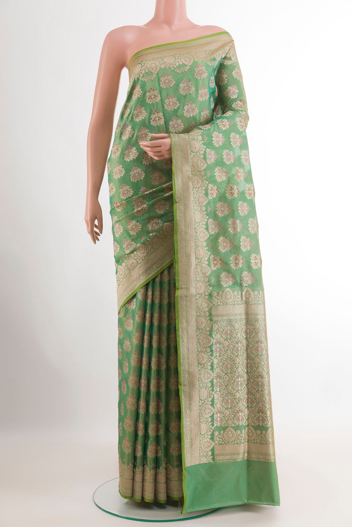 Green Banarasi Silk Saree with Zari Brocade on the body and Zari Border.  displayed on a mannequin