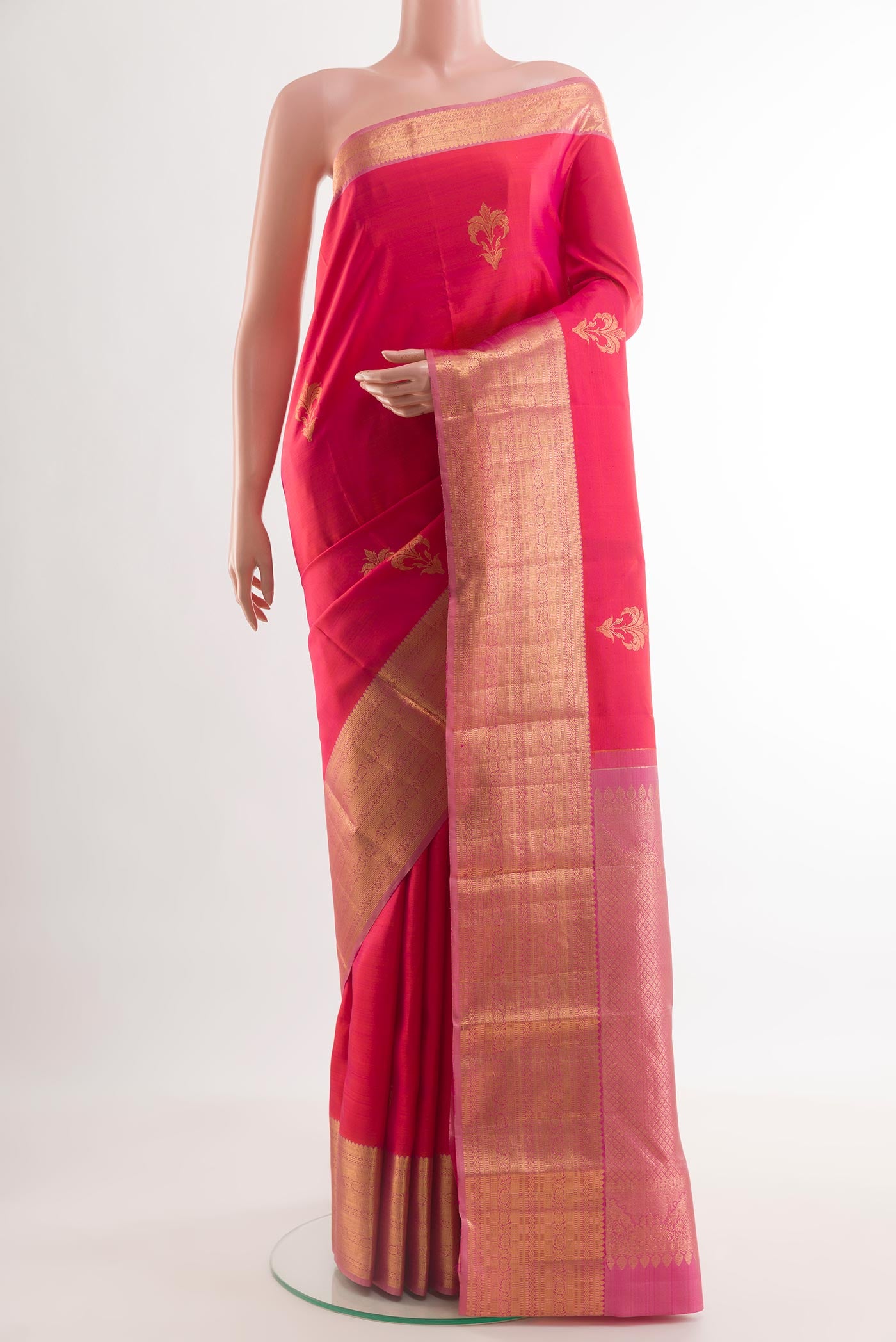 Pink Kanchipuram Silk Saree with Zari Butta on the body and Zari Border.  displayed on a mannequin