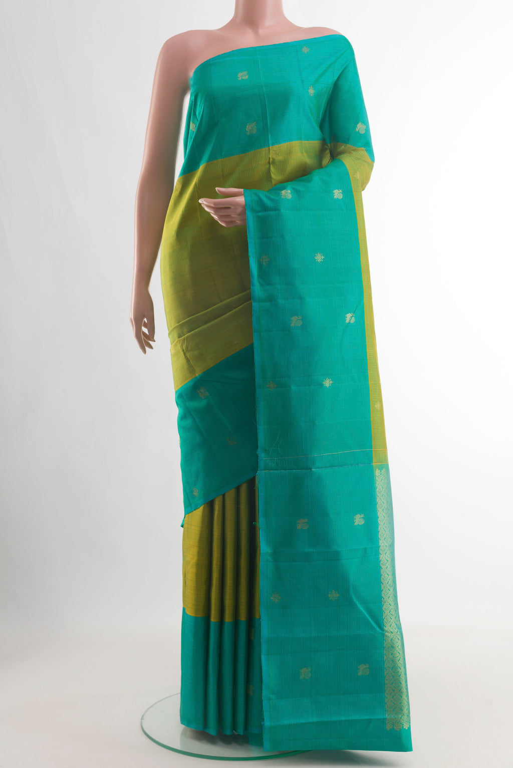 Green Kanjivaram Silk Saree with Zari Butta on the body and Zari Border.  displayed on a mannequin