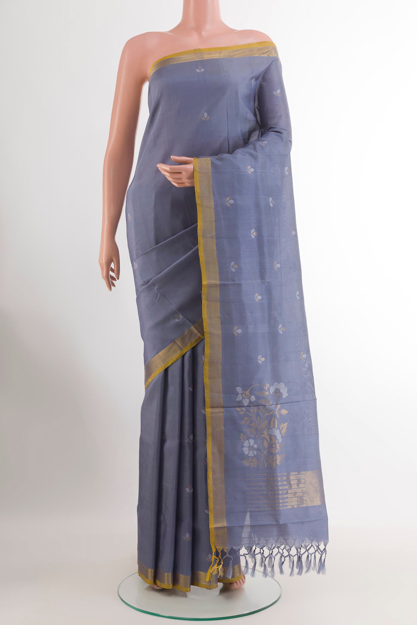 Blue Uppada Silk Saree with Zari Butta on the body and Zari Border.  displayed on a mannequin