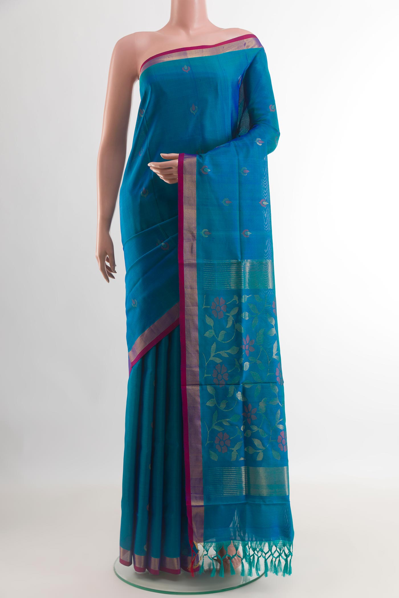 Blue Uppada Silk Saree with Zari Butta on the body and Zari Border.  displayed on a mannequin