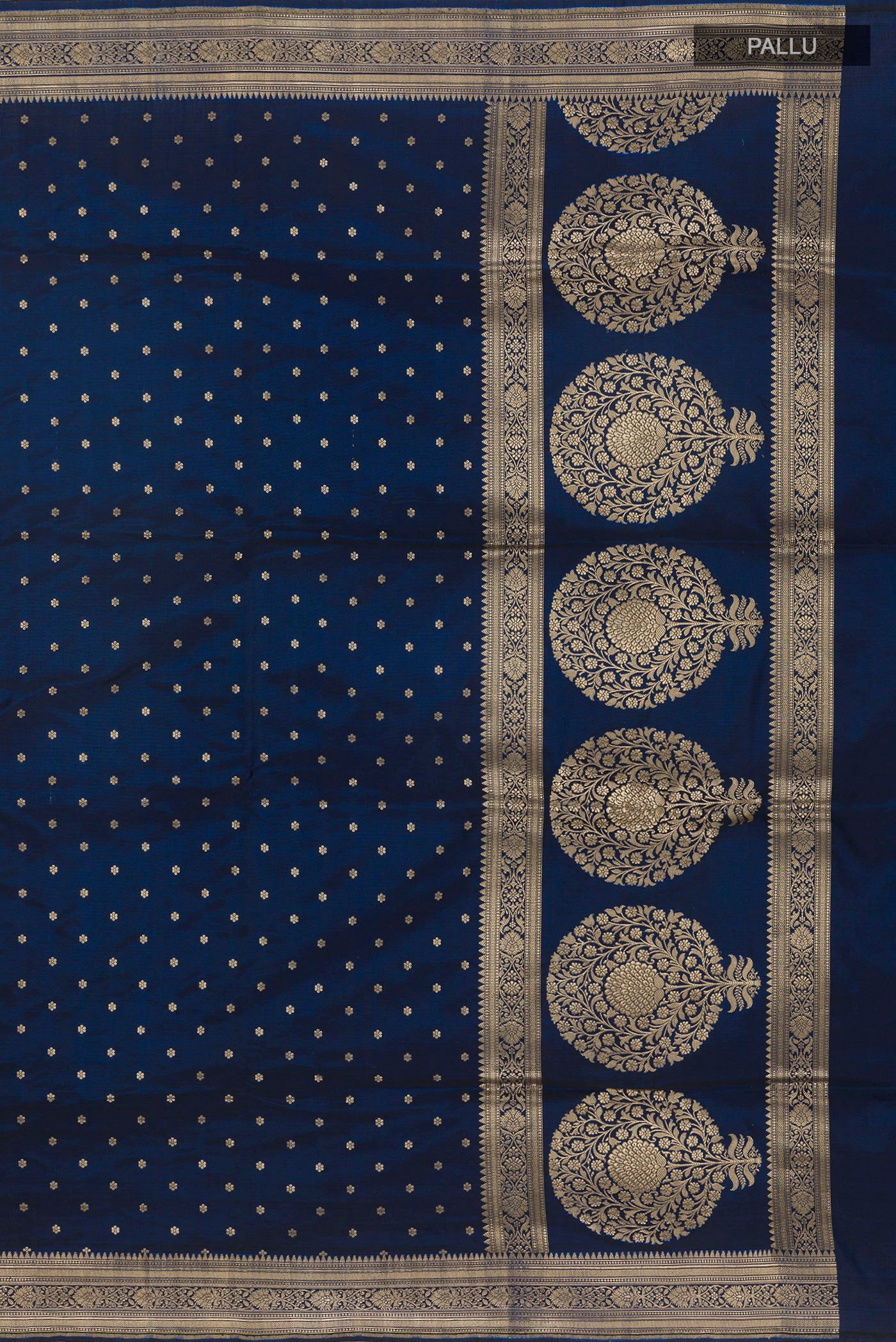 Close up image of the pallu of Blue Banarasi Silk Saree with Zari Butta on the body and Zari Border. 
