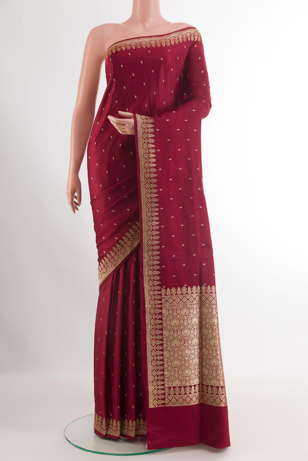 Maroon Banarasi Silk Saree with Zari Butta on the body and Zari Border.  displayed on a mannequin