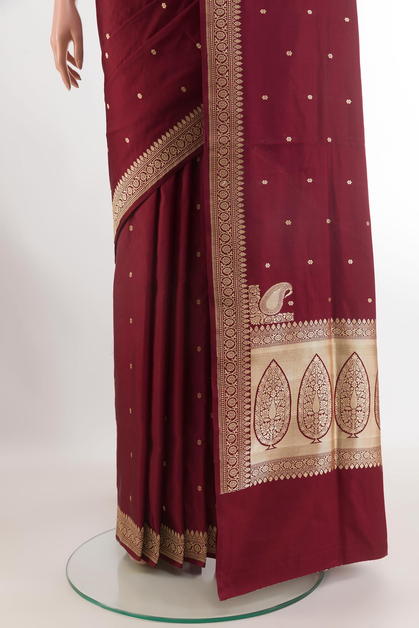 Pleats and pallu of Maroon Banarasi Silk Saree with Zari Butta on the body and Zari Border. 