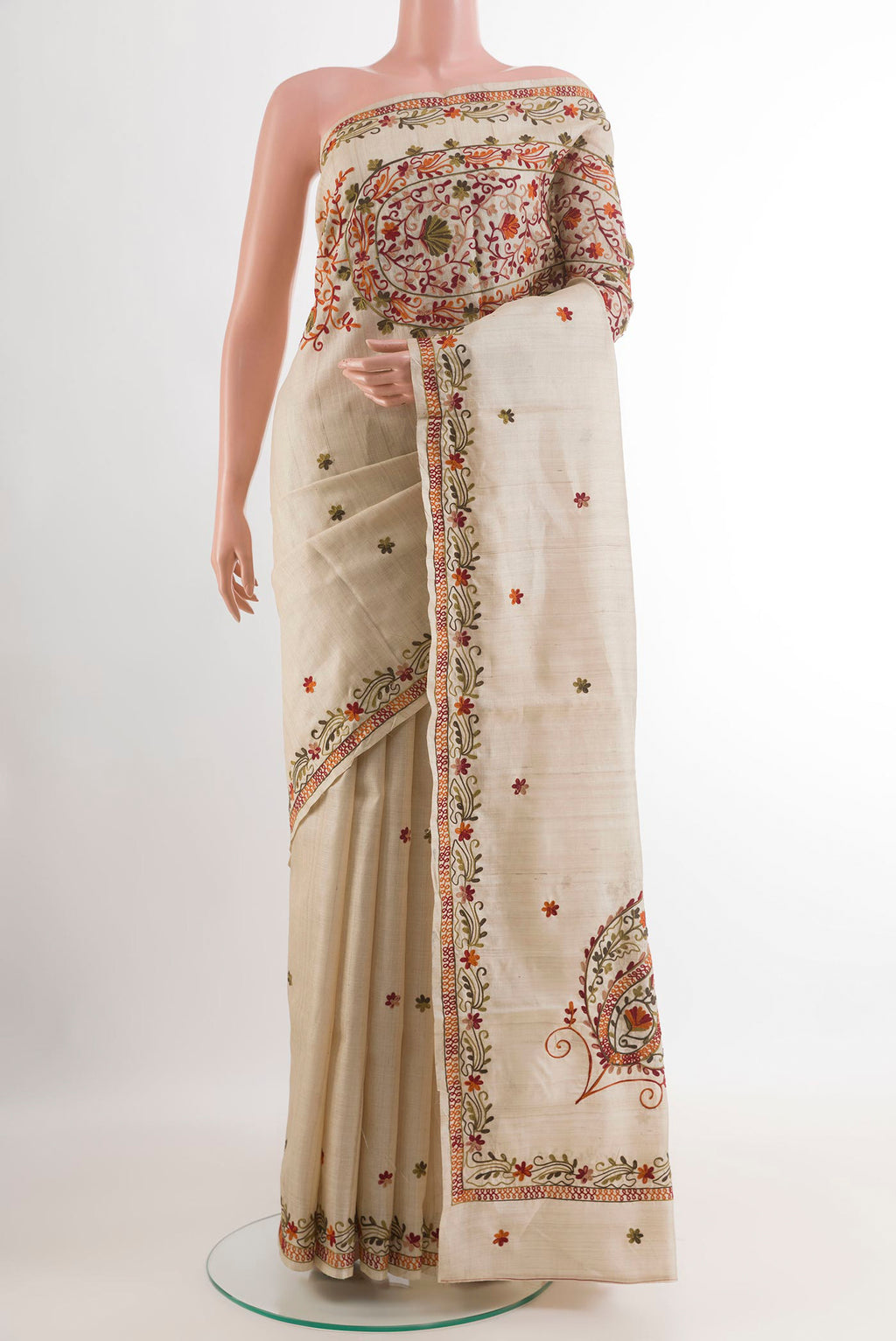 Off White Tussar Saree with Embroidery on the body and Embroidery Border.  displayed on a mannequin