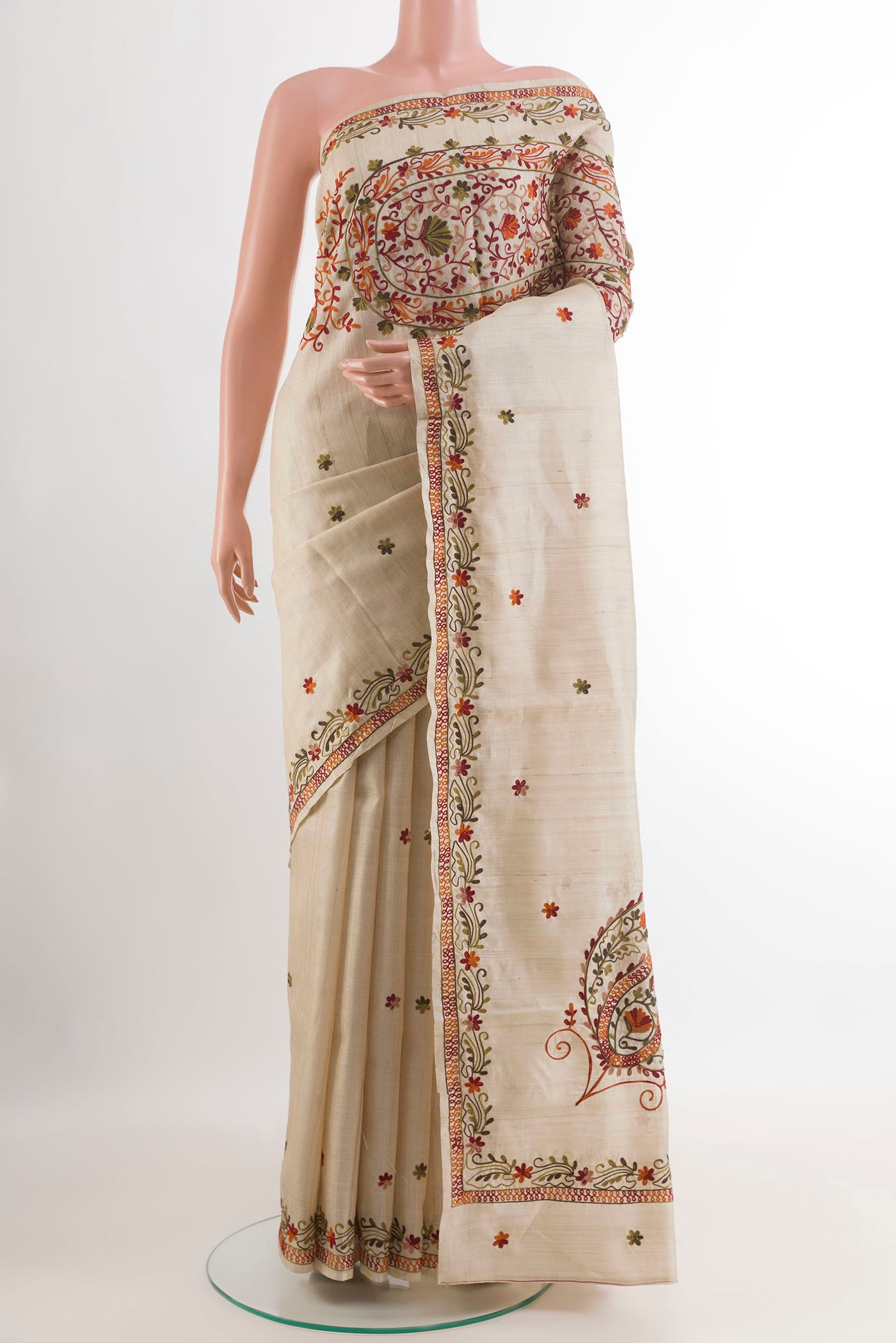 Off White Tussar Saree with Embroidery on the body and Embroidery Border.  displayed on a mannequin
