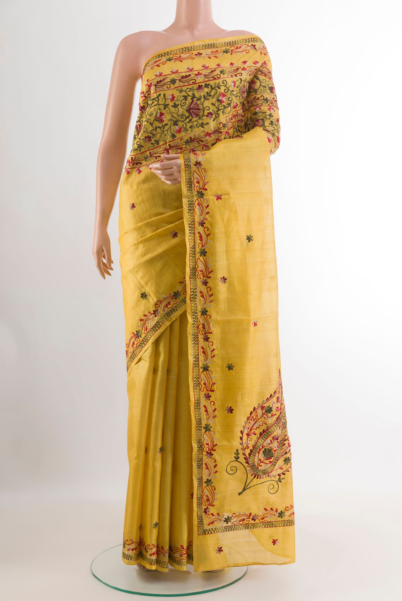 Yellow Tussar Saree with Embroidery on the body and Embroidery Border.  displayed on a mannequin