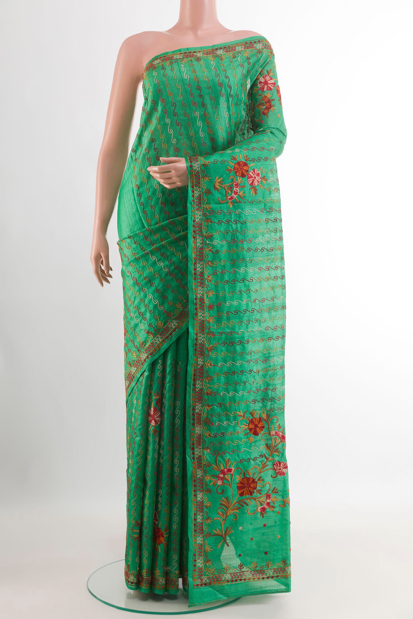 Green Tussar Saree with Embroidery on the body and Embroidery Border.  displayed on a mannequin