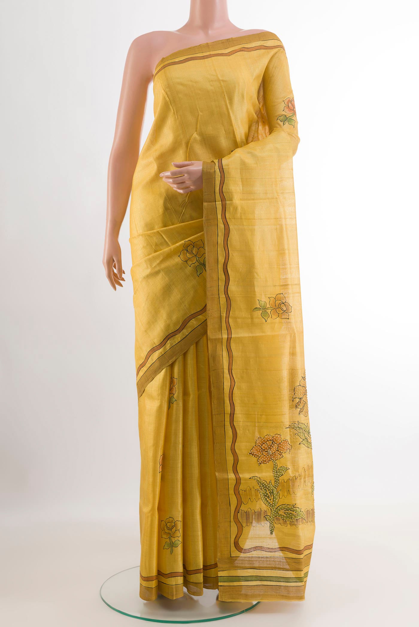 Yellow Tussar Saree with Printed design on the body and Printed Border.  displayed on a mannequin