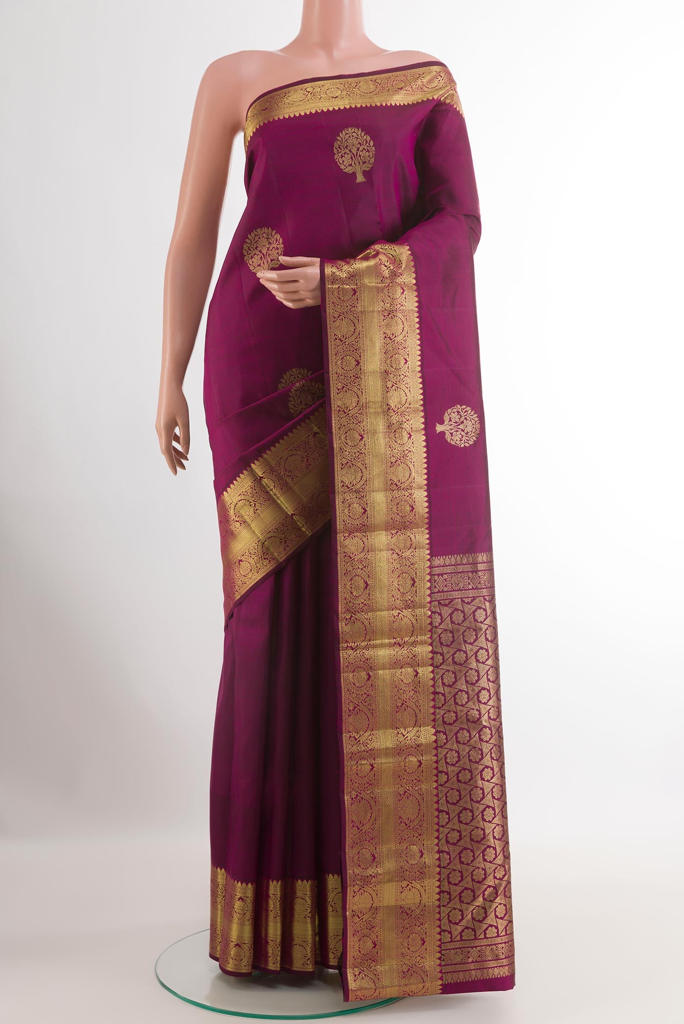 Purple Kanchipuram Silk Saree with Zari Butta on the body and Zari Border.  displayed on a mannequin
