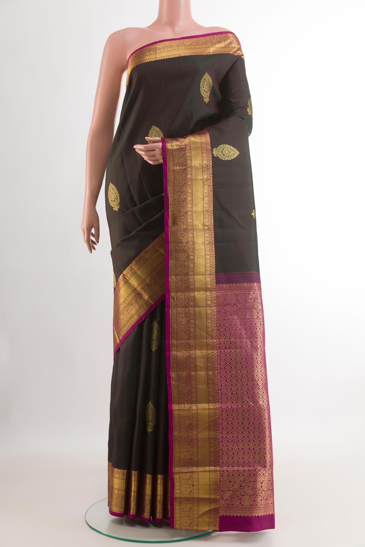 Black Kanchipuram Silk Saree with Zari Butta on the body and Without Border.  displayed on a mannequin
