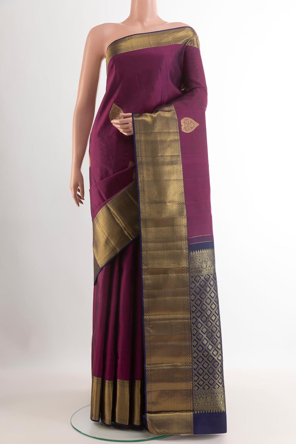 Purple Kanchipuram Silk Saree with Zari Butta on the body and Zari Border.  displayed on a mannequin