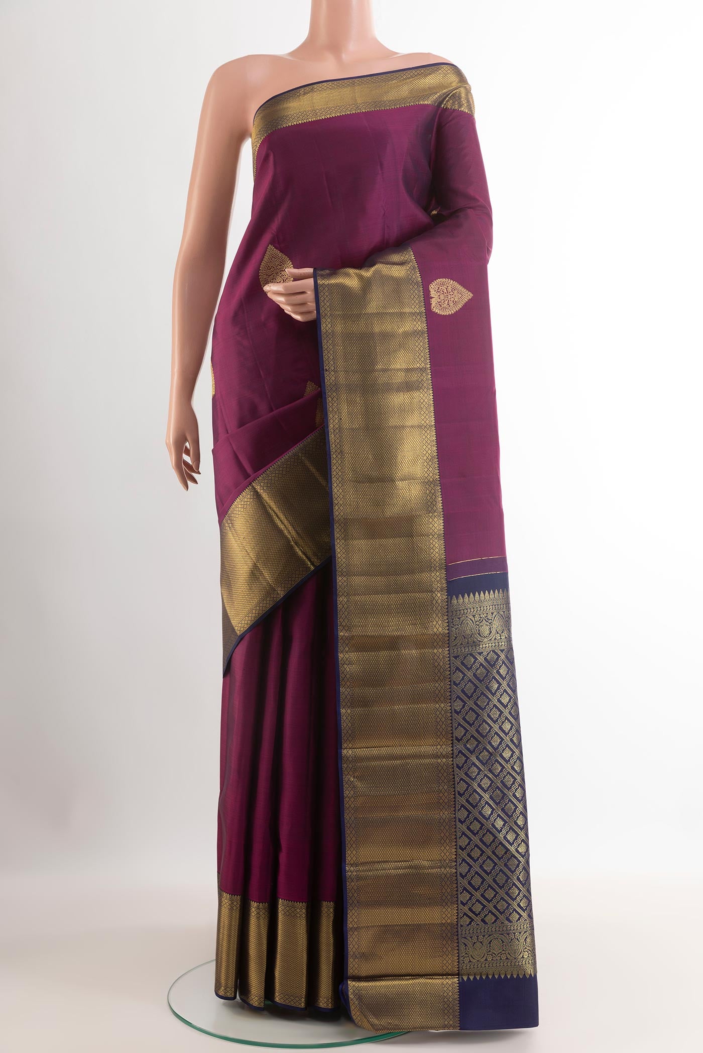 Purple Kanchipuram Silk Saree with Zari Butta on the body and Zari Border.  displayed on a mannequin