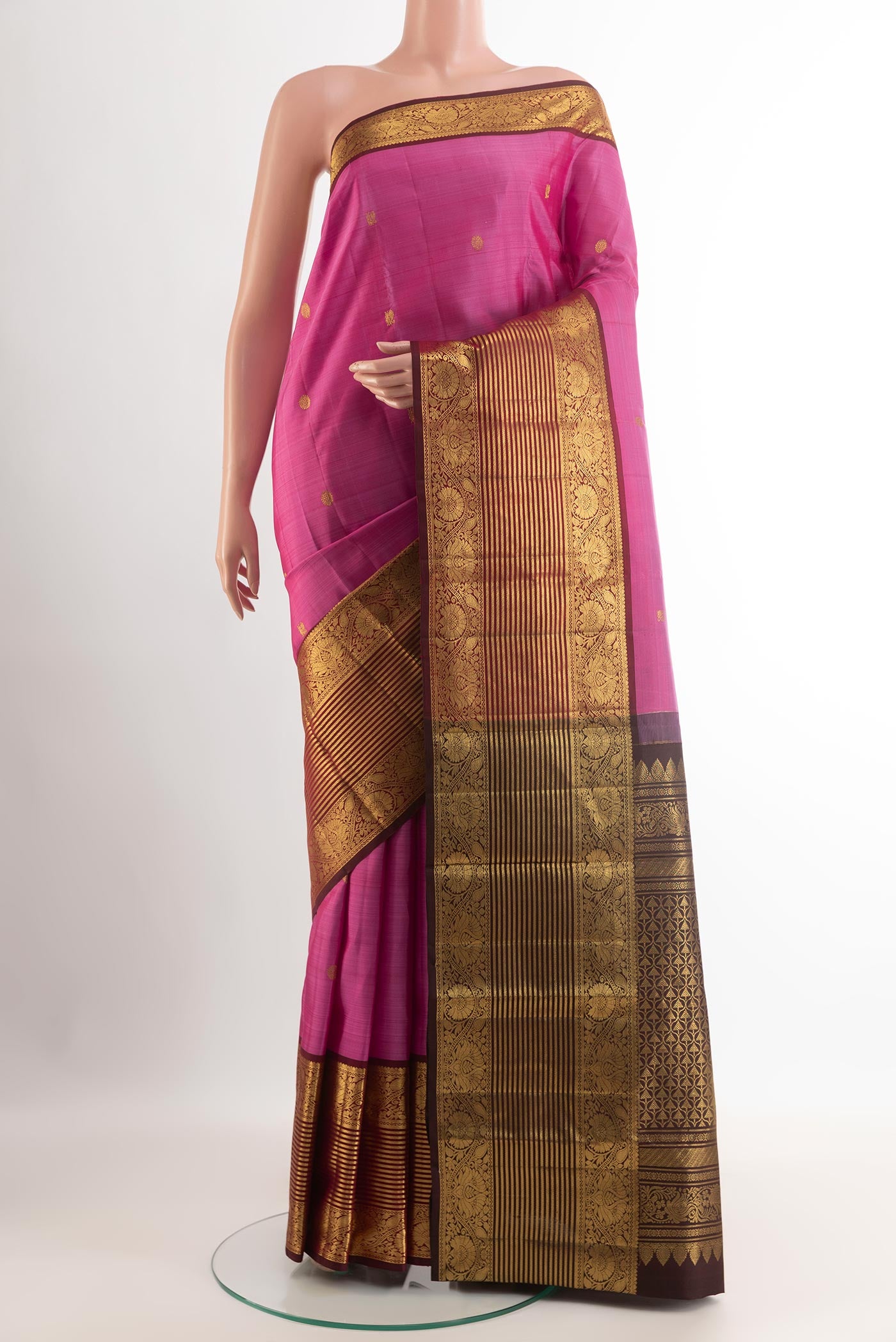 Pink Kanchipuram Silk Saree with Zari Butta on the body and Zari Border.  displayed on a mannequin