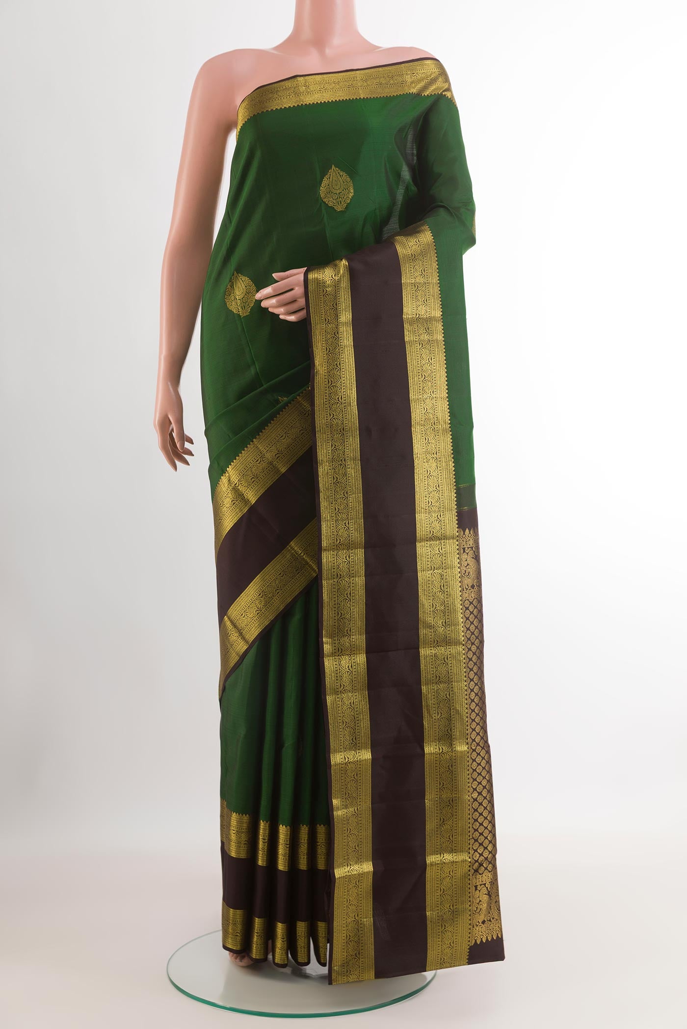 Green Kanchipuram Silk Saree with Zari Butta on the body and Zari Border.  displayed on a mannequin