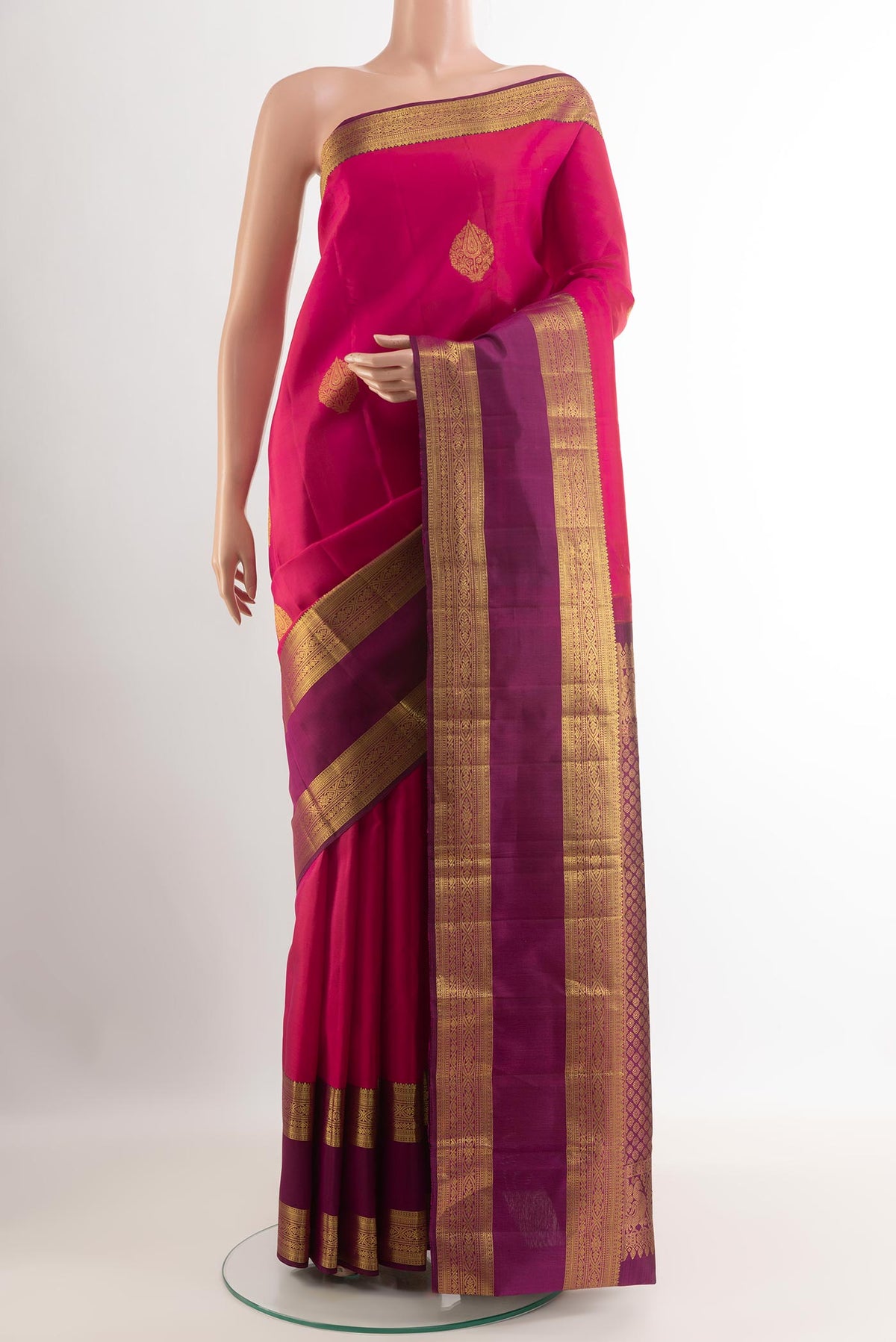 Red Kanchipuram Silk Saree with Zari Butta on the body and Zari Border.  displayed on a mannequin