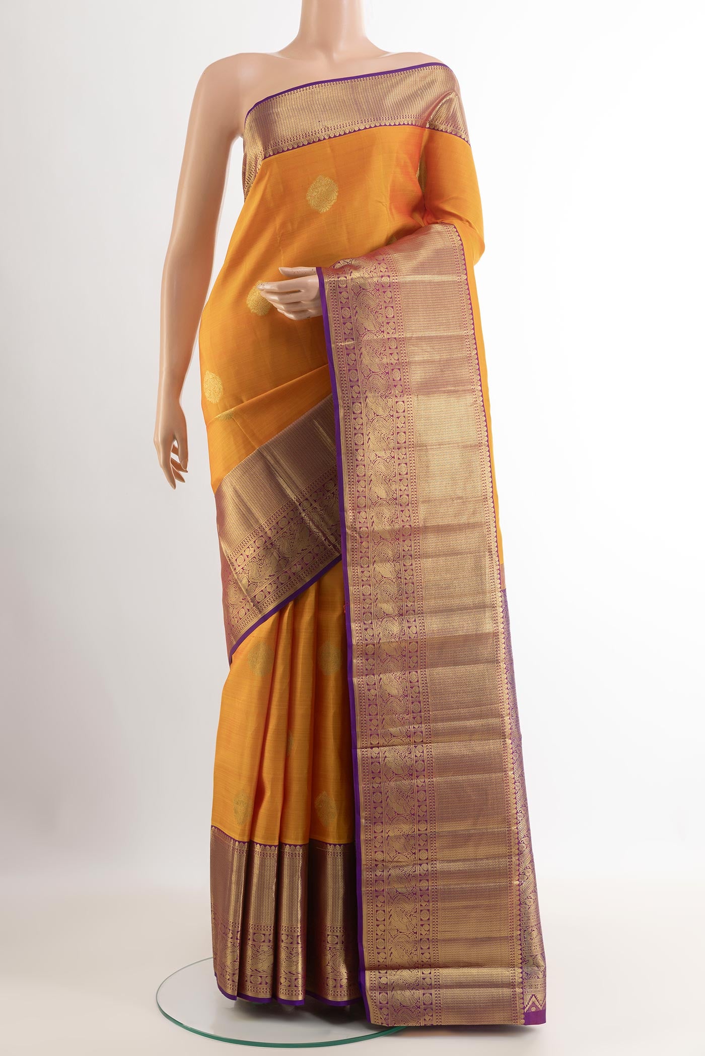Yellow Kanchipuram Silk Saree with Zari Butta on the body and Zari Border.  displayed on a mannequin