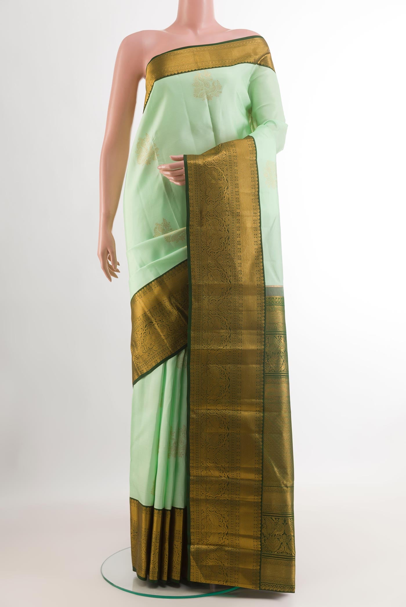 Mint Green Kanjivaram Silk Saree with Zari Brocade on the body and Zari Border.  displayed on a mannequin