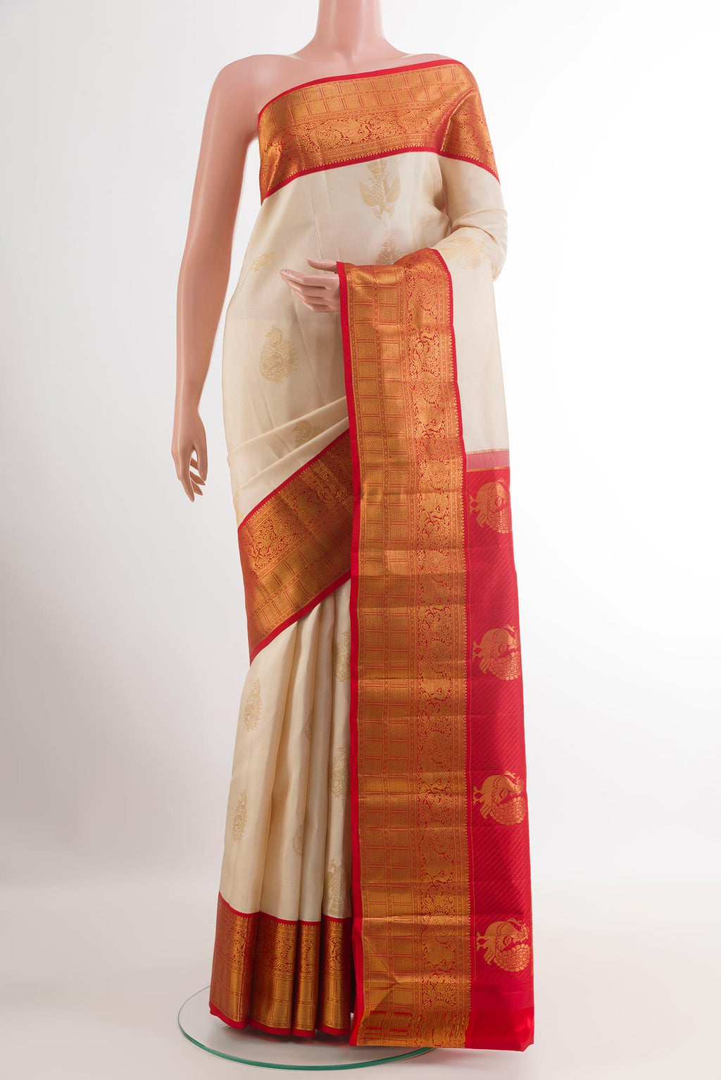 Off White Kanjivaram Silk Saree with Zari Butta on the body and Zari Border.  displayed on a mannequin