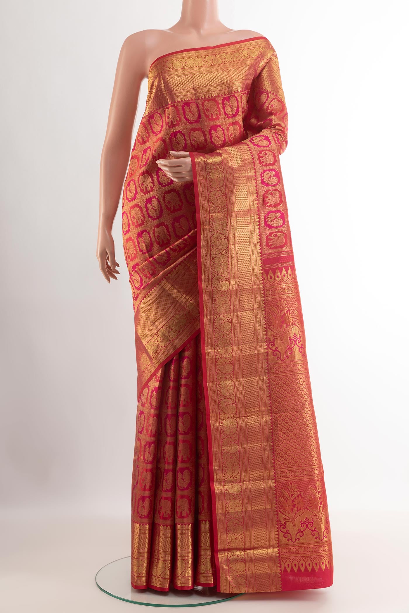 Red Kanchipuram Silk Saree with Zari Brocade on the body and Zari Border.  displayed on a mannequin
