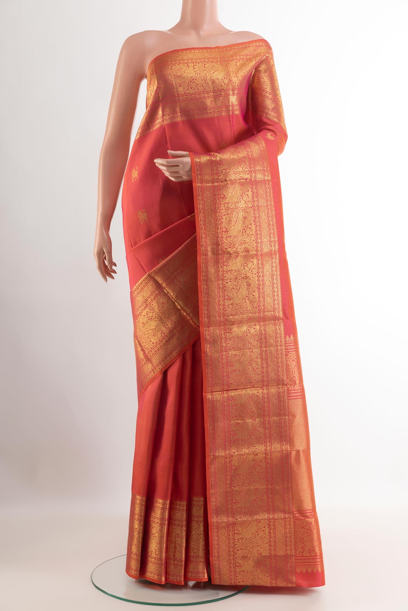 Pink Kanchipuram Silk Saree with Zari Butta on the body and Zari Border.  displayed on a mannequin