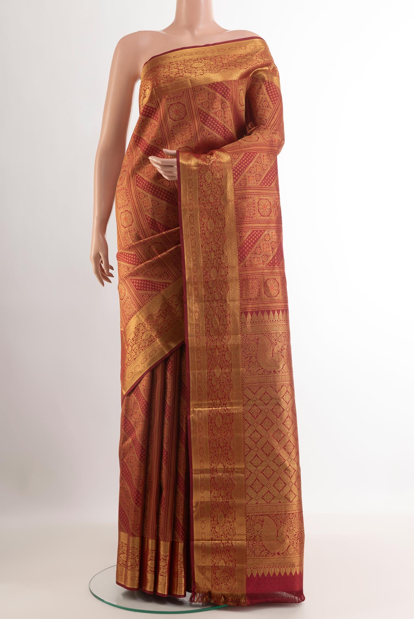 Maroon Kanjivaram Silk Saree with Zari Brocade on the body and Zari Border.  displayed on a mannequin