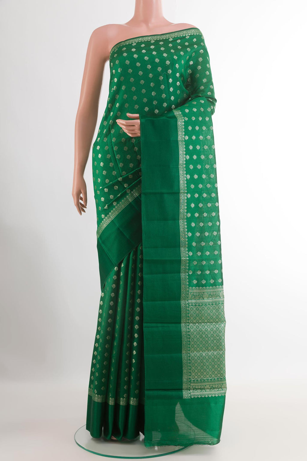 Green Tussar Silk Saree with Zari Butta on the body and Zari Border.  displayed on a mannequin