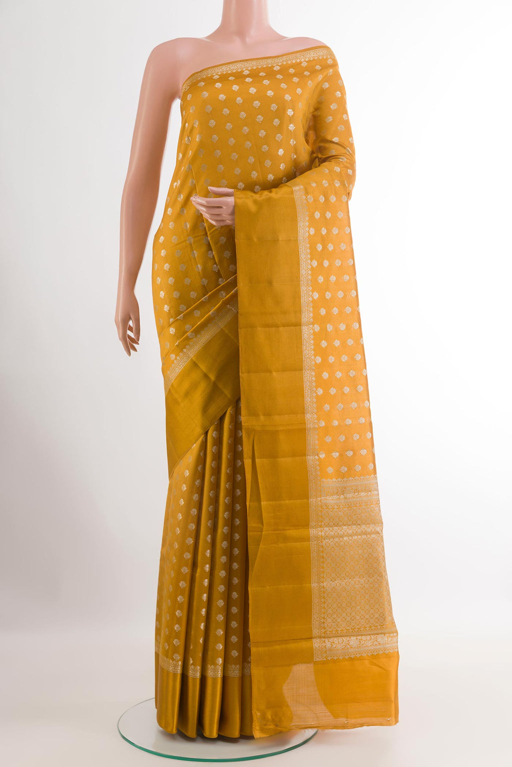 Yellow Tussar Silk Saree with Zari Butta on the body and Zari Border.  displayed on a mannequin