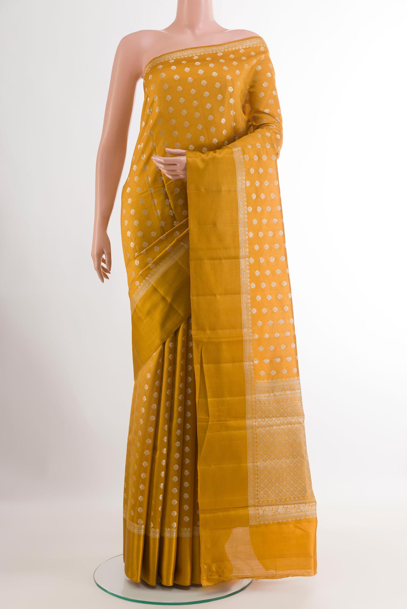 Yellow Tussar Silk Saree with Zari Butta on the body and Zari Border.  displayed on a mannequin