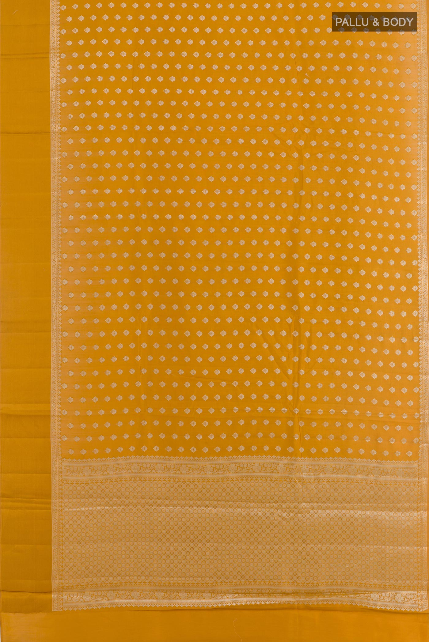 Flat view of Yellow Tussar Silk Saree with Zari Butta on the body and Zari Border. 