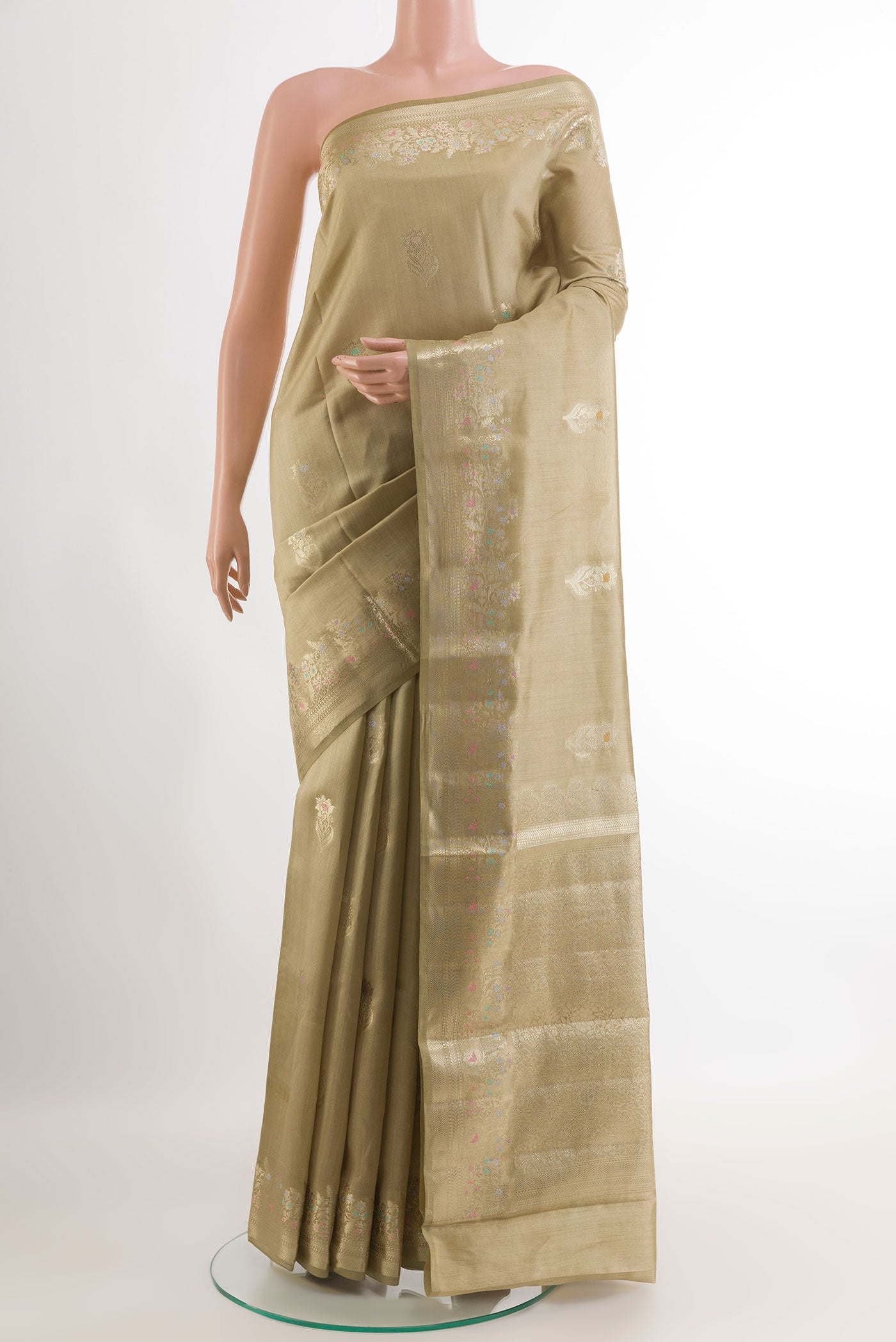 Beige Tussar Silk Saree with Zari Butta on the body and Zari Border.  displayed on a mannequin