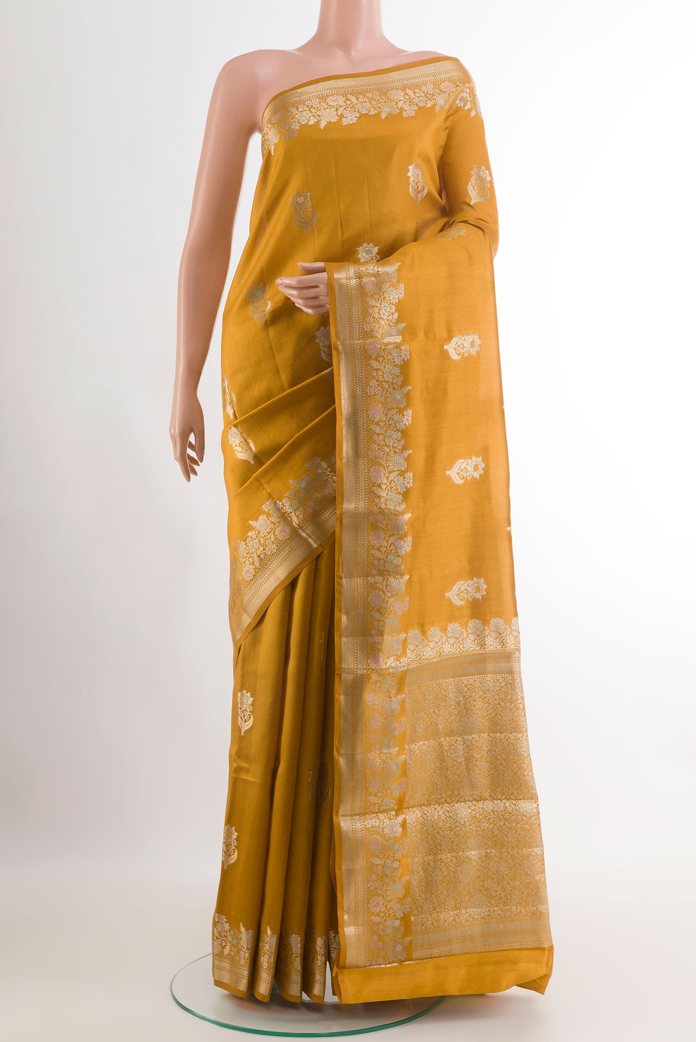 Mustard Tussar Silk Saree with Zari Butta on the body and Zari Border.  displayed on a mannequin