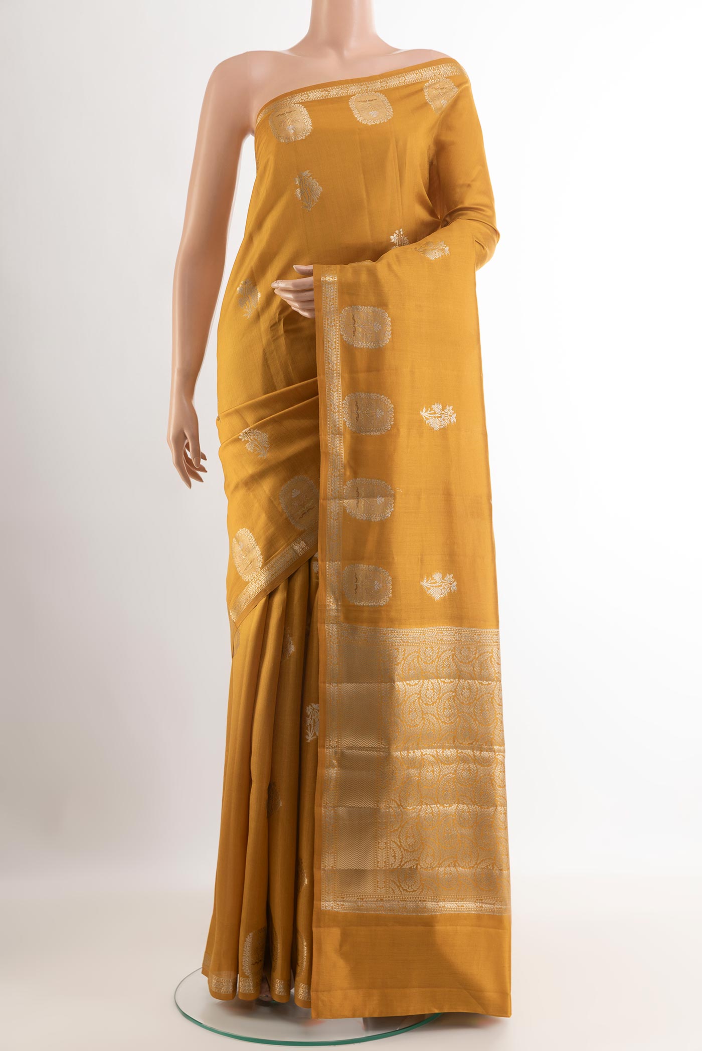 Yellow Tussar Silk Saree with Zari Butta on the body and Zari Border.  displayed on a mannequin
