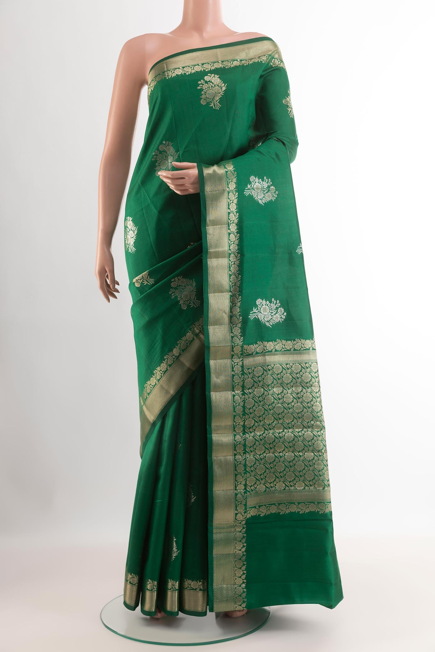 Green Tussar Silk Saree with Zari Butta on the body and Zari Border.  displayed on a mannequin