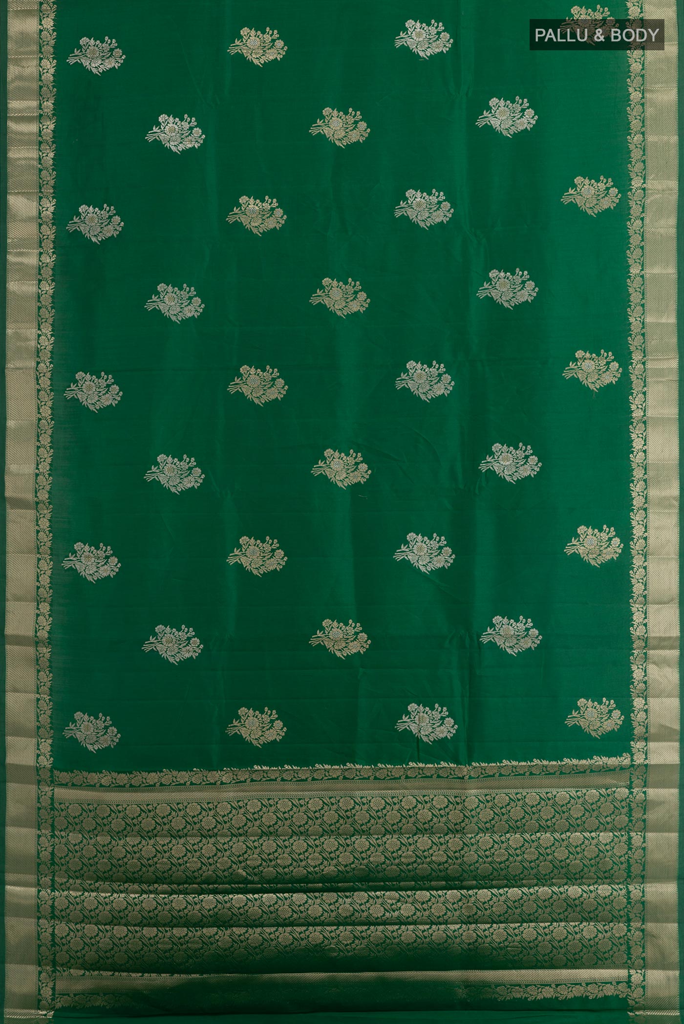 Flat view of Green Tussar Silk Saree with Zari Butta on the body and Zari Border. 
