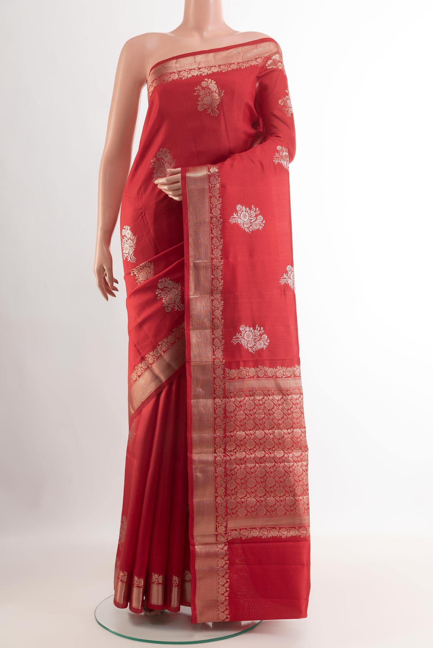 Red Tussar Silk Saree with Zari Butta on the body and Zari Border.  displayed on a mannequin