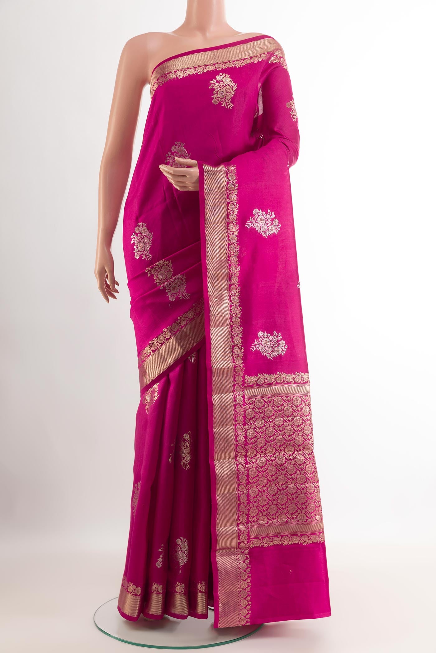 Pink Tussar Silk Saree with Zari Butta on the body and Zari Border.  displayed on a mannequin