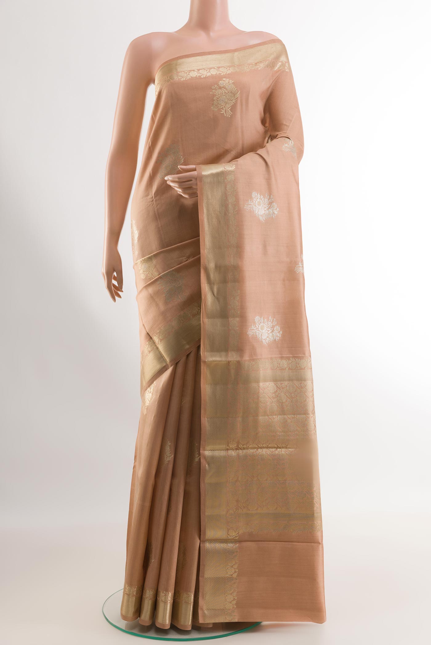 Beige Tussar Silk Saree with Zari Butta on the body and Zari Border.  displayed on a mannequin