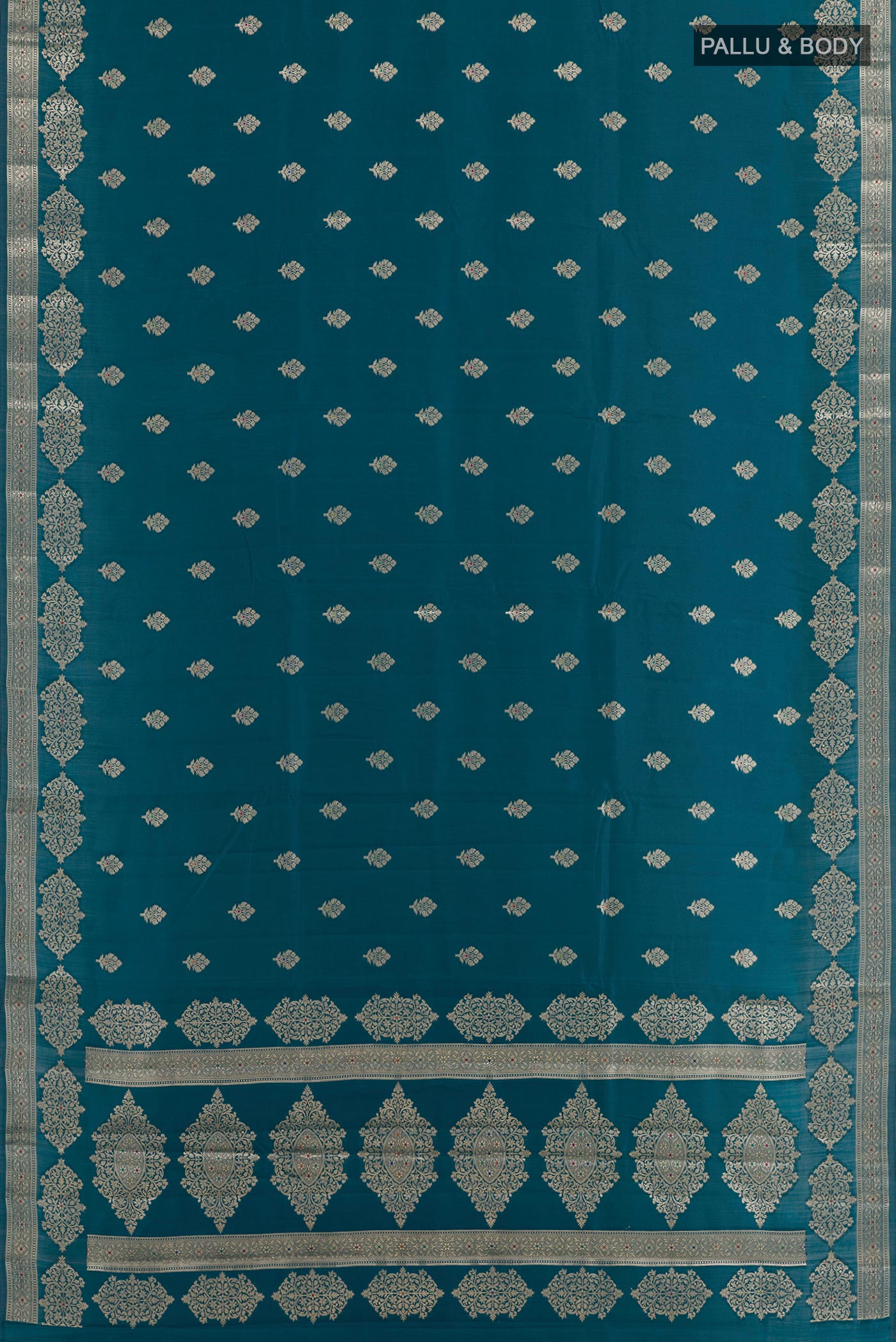 Flat view of Blue Tussar Silk Saree with Zari Butta on the body and Zari Border. 
