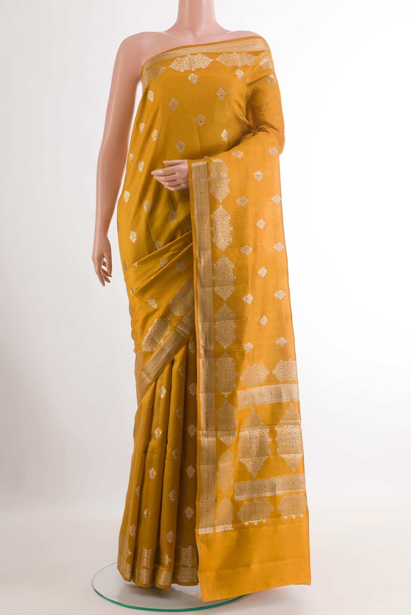 Yellow Tussar Silk Saree with Zari Butta on the body and Zari Border.  displayed on a mannequin